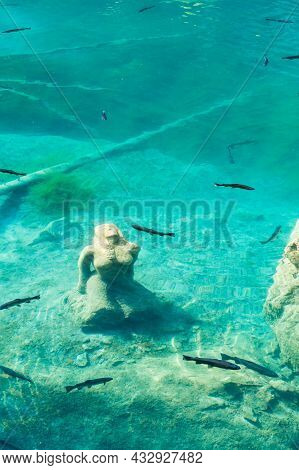 Maiden Statue And Trouts In The Blausee (blue Lake), Switzerland
