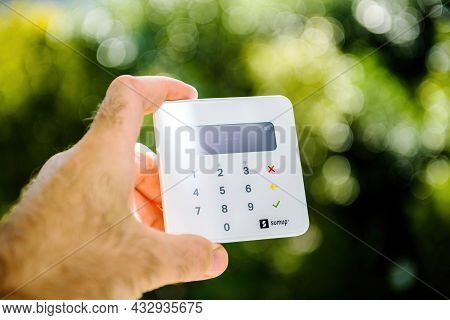 Paris, France - Sep 8, 2021: Male Hand Holding New Sumup Emv Card Reader Which Can Read Magnetic Str