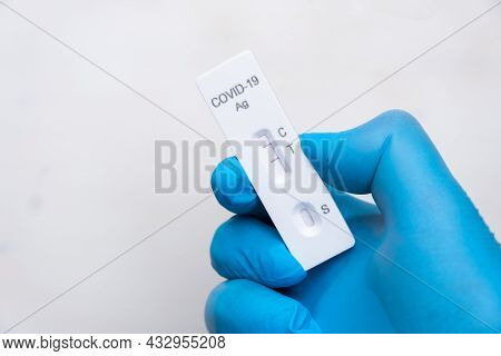 Positive Covid-19 Antigenic Test For Quick Detection Of Disease In Doctors Hand In The Rubber Gloves