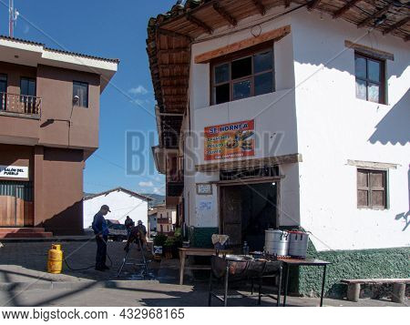 Nabon, Ecuador - September 5, 2021: Man Prepares Chancho Hornado Or Roasted Pig Which Is Typical Ecu