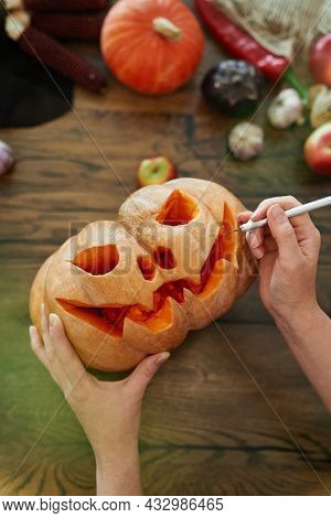 Female Hands Pumpkin Carving Or Halloween Concept. Top View Of Pumpkin As Autumn Seasonal Tradition.