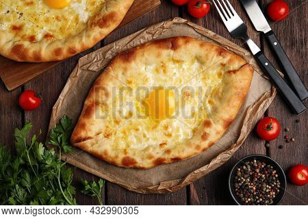Fresh Delicious Adjarian Khachapuris Served On Wooden Table, Flat Lay