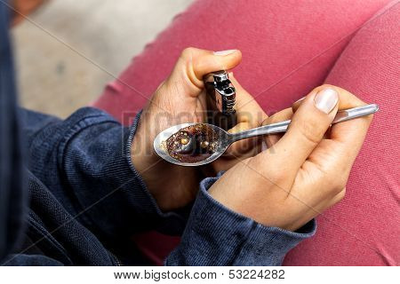 Junkie Preparing A Dose Of Heroin