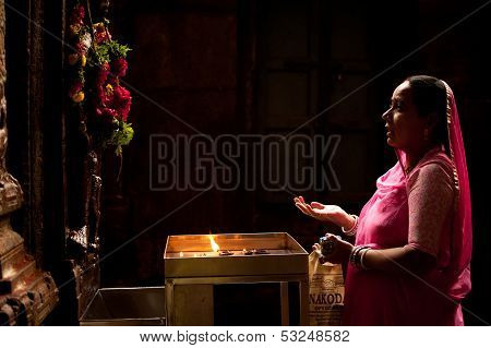 Madurai, India - February 16: Indian Woman In Colorful Sari Prays Inside Meenakshi Temple On Februar