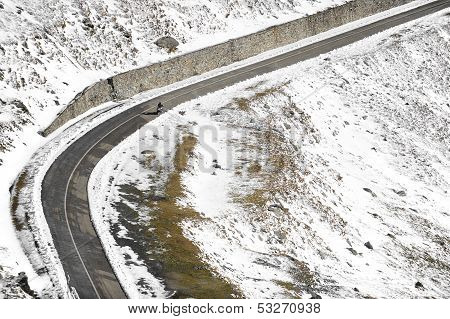 Motorcyclist On High Mountain Road
