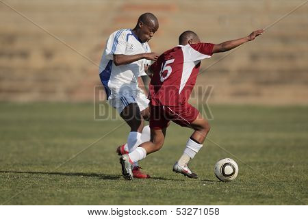 BLOEMFONTEIN, SOUTH AFRICA - AUGUST 7: Unidentified players during a men's soccer match between the North West and Free State Universities, on Aug 7, 2010 in Bloemfontein, South Africa.
