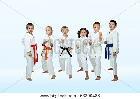 On a light background six athletes perform tehniques
