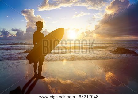 Surfer Man Standing On Beach And Holding A Surfboard