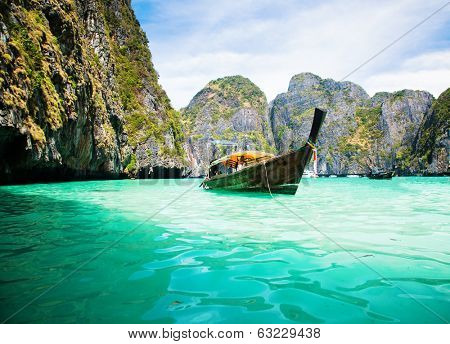 Thailand ocean landscape. Exotic beach view and traditional ship in Maya Bay, Ko Phi Phi Don