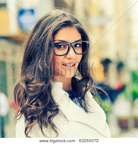 Beautiful Woman With Eye Glasses Smiling In Urban Background
