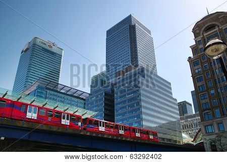 ONDON, CANARY WHARF UK - APRIL 13, 2014 - DLR bridge with train Modern glass architecture