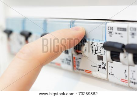 Man Turning On The Fusebox