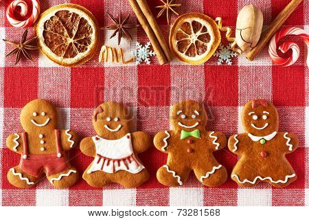 Christmas homemade gingerbread couples on tablecloth