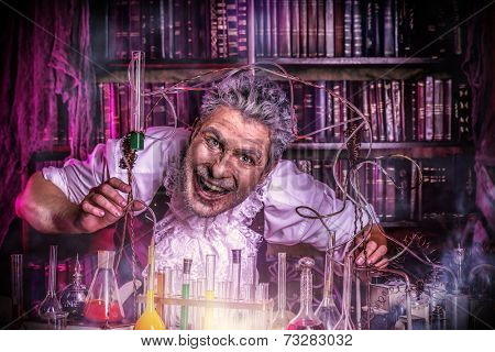 Crazy old man medieval scientist working in his laboratory. Alchemist. Halloween.