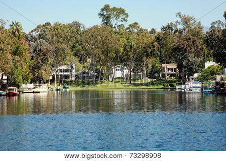 Private Lake with homes and boats in Lake Forest California. Lake Forest has many Private Lakes with limited access to the general public, making it an ideal and serene location to live life. 