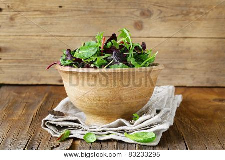 mix salad (arugula, iceberg, red beet) in a wooden bowl