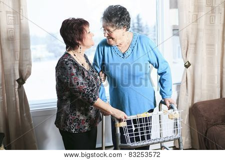 A daughter with is mother help with walker