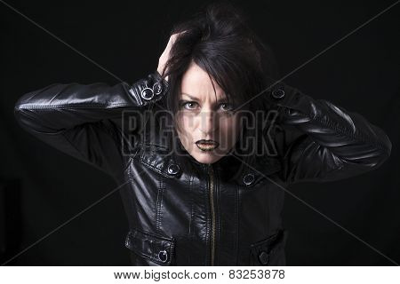 A gothic woman over a dark background,