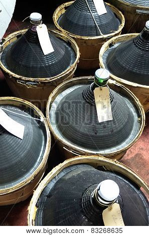 Carboys and wooden barrels filled with wine