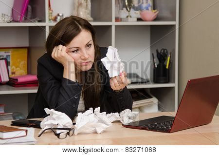 Sad Girl In The Office Holds A Crumpled Sheet Of Paper