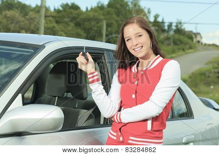 Car driver woman happy showing car keys out window