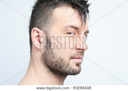 A sexy portrait of a man over a gray background