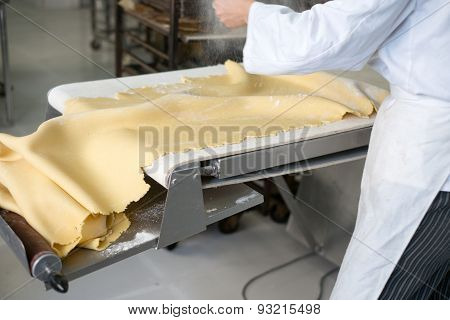 Sprinkling Flour On Sheet Of Pie Dough