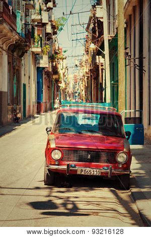 HAVANA,CUBA - MAY 30,2015 : Old russian car on a typical neighborhood with decaying buildings in Old Havana