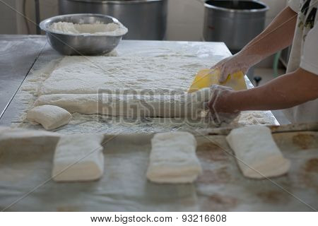 Baker Cutting Raw Ciabatta Bread Dough