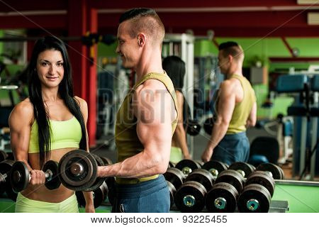Fitness Youple Workout - Fit Mann And Woman Train In Gym