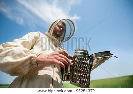 beekeeper with smoke tool