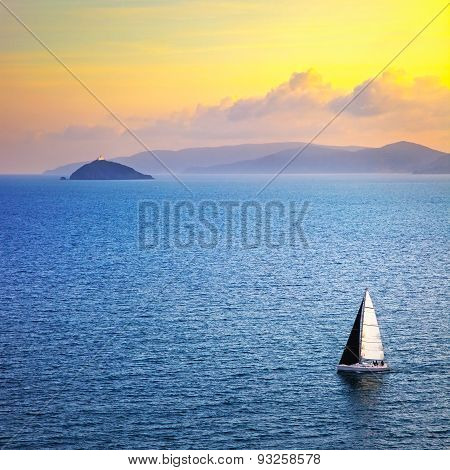 Elba Island Sunset View From Piombino An Sail Boat. Mediterranean Sea. Italy