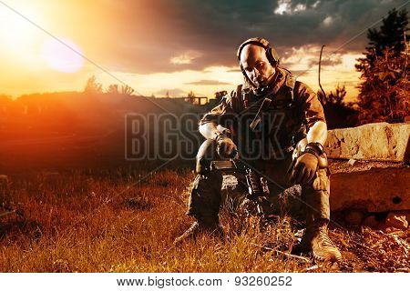 American Soldier With The M4 Rifle Is Having A Rest. Sunset On The Background.