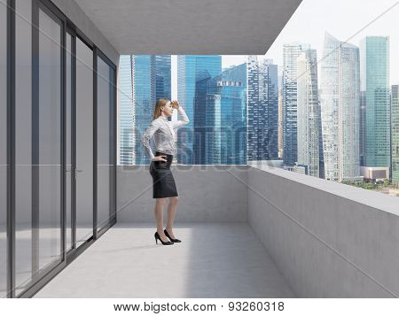 Young Business Lady Is Standing On The Balcony Of The Skyscraper And Looking At The New Business Per