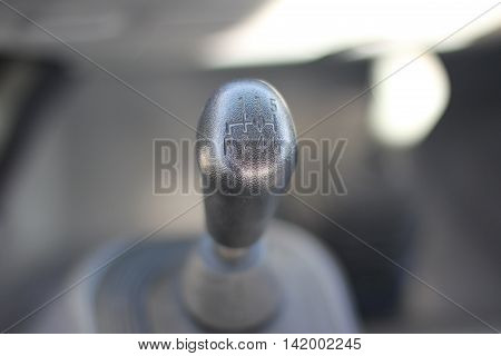 the shift lever in the cabin of the car