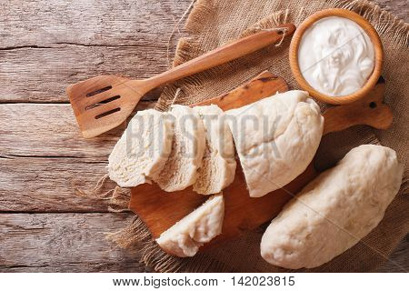 Czech Cuisine: Sliced Boiled Knedliks Close-up On Chopping Board. Horizontal Top View