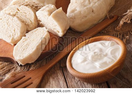 Czech Sliced Knedliks With Sour Cream Close-up. Horizontal