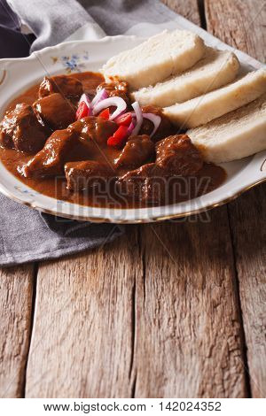 Czech Food: Goulash With Knedle On The Table Close-up. Vertical