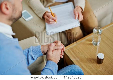 Hands of stressed man showing tensity