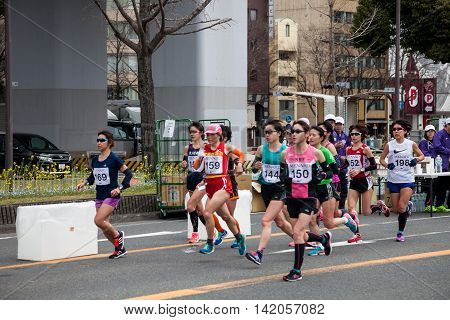 NAGOYA JAPAN - MARCH 13 2016: Nagoya Women's Marathon 2016. Women's running in the downtown. Course Start and finish at Nagoya Dome Distance 42.195km. Nagoya city Japan.