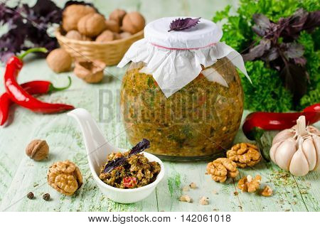 Homemade sauce adjika with hot pepper garlic basil parsley and walnuts. Tabasco
