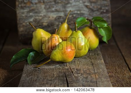 Sweet yellow pears lying on a wooden serface