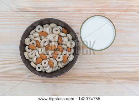 Healthy breakfast cereal with milk, on the beautiful wooden board