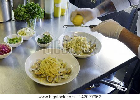 Preparetion dish of spaghetti with clams in a restaurant kitchen