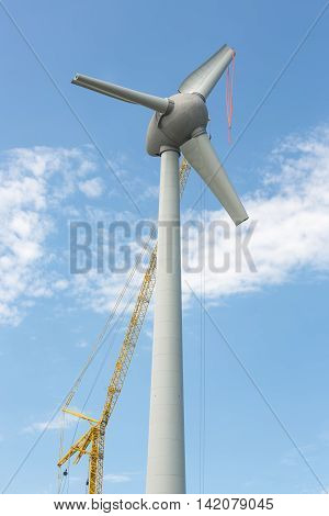 Assembling wings new Dutch windturbine with large crane