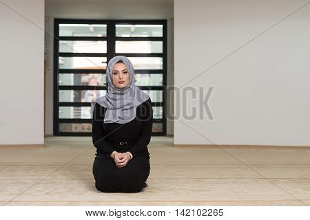 Young Caucasian Woman Praying With Head Dress