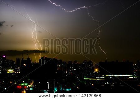 Dramatic thunder storm lightning bolt on the horizontal sky and city scape