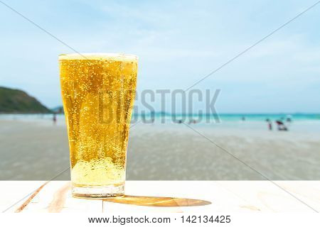 Beer glass on a blurred background of the sea.