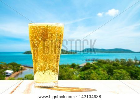 Beer glass on a blurred background of the sea.