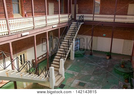 NEW NORCIA,WA,AUSTRALIA-JULY 15,2016: Outdoor courtyard with balcony and double stairway at St. Ildephonsus College for Boys in the historic monastic town of New Norcia, Western Australia.